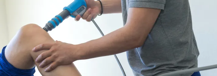 Chiropractic-West-Des-Moines-IA-Shockwave-Therapy-on-Patient-Knee.webp